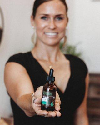 Nicole holding one of her favorite tinctures