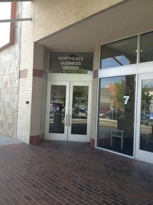 This is the door that opens to an elevator or stairs, which lead down to her place of business. To the left of the Ruby Tuesday.