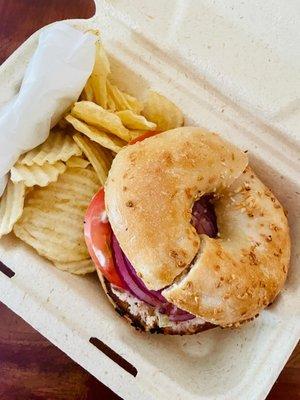 Onion bagel toasted with Vegetable Cream Cheese, onions and tomatoes