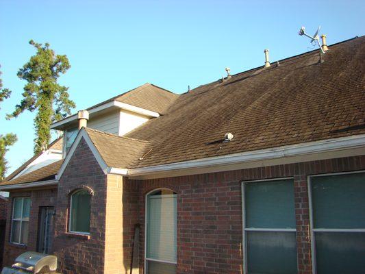 1st Home:
 The rear of the home with badly worn out shingles.