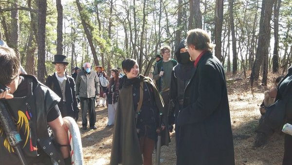 Group of Live Action Role Players or Larpers walking through a forest.