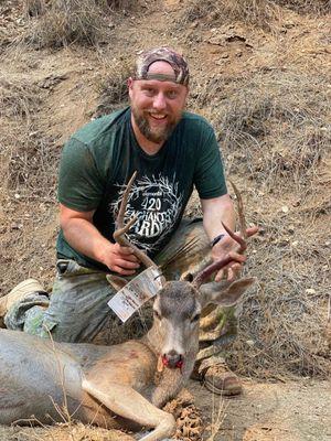 Photo with buck I harvested using aim scope.  1 nicely placed shot.