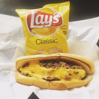 Philly cheesesteak, tender sliced ribeye steak grilled with sautéed peppers and onions.