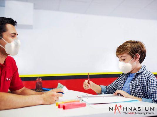 Instructor helping student with his work.