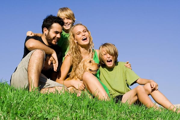 happy family seated together on hill