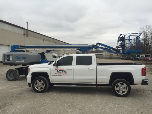 Company truck and new 65' boom lift for rental.