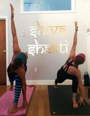 Co-owner Naima and Rachel the teacher in crescent lunge