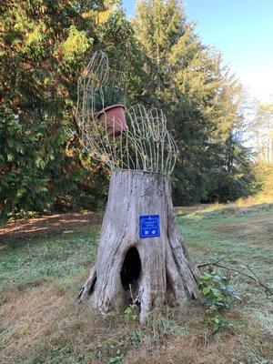 Stump with sculpture/wire hand.