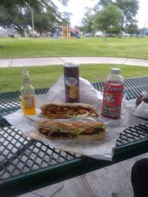 Enjoying the evening at the park. Hot sausage poboy, orange Smirnoff, shrimp poboy and Arizona tea! Yes!