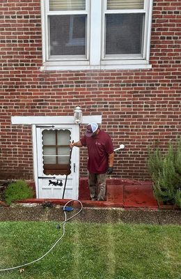 Technician running water through drain after clearing out mud and other debris.