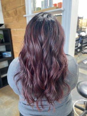 Deep cranberry hair color with a dark root smudge.