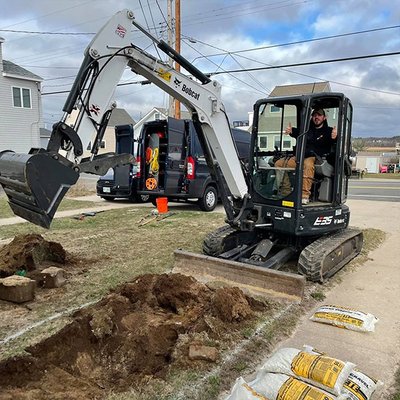 Andrew digging up a broken sewer line in wells