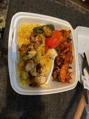 Chicken kabob with rice and potatoes.