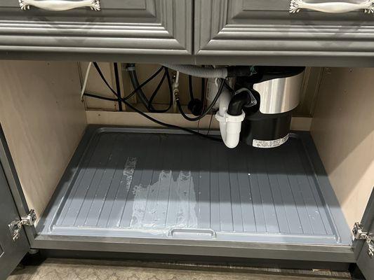 No backs to cabinets, electrical mess that gets wet when faucet leaks