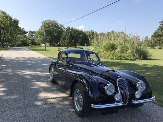 An XK120 going home after receiving a full restoration from our talented team here at Muncie Imports & Classics.