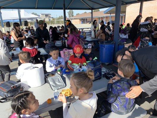 Students eating lunch during the Halloween Carnival of 2019.