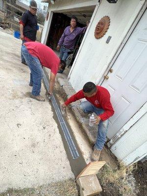 Steel grate drainage installed in concrete to prevent water from flooding garage