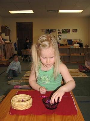 Child Doing Beading, which improves concentration and coordiantion