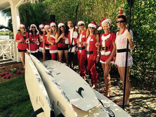 20 "Santas" ready for paddleboarding with boards just delivered from Hu'i Hu'i.