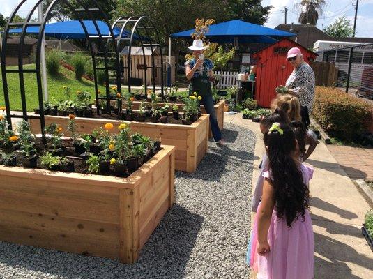 Raised garden beds help children learn about planting, tending, and eating healthy.