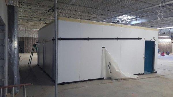 Working on the installation of a walk-in cooler for a client