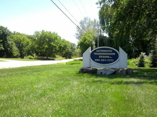 The front sign for Automatic Transmission Design as viewed from Highway 145/Fond Du Lac Ave.