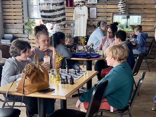 Darlene Hudson (center) and two of her students enjoying chess and some kind of cold coffee "brewhaha".