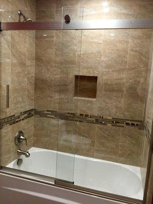 They installed this tub, sliding glass door, did the tile work, and all the trimmings. I am so happy with how chic it turned out!