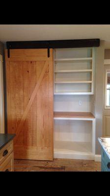 Custom pantry with bypass barn doors.