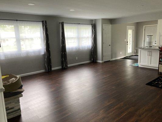 Living room renovation. New floors, trim, coat closet, doors, ceiling and lights.