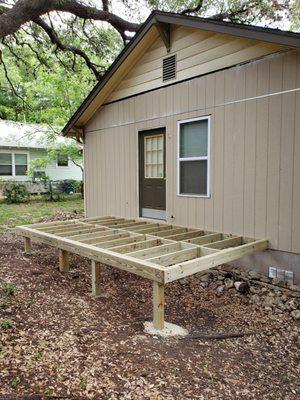 Here is the back of the house with new siding and the foundation of the new patio room.