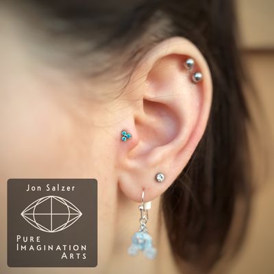 Mint green trinity end in a tragus