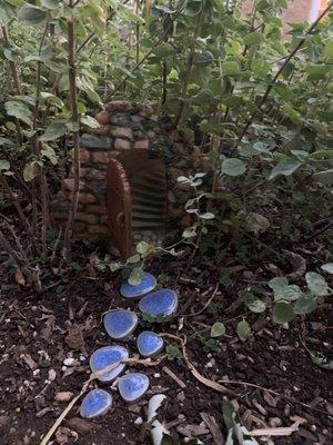 A mysterious door (buried deep in oregano) with steps leading ... who knows where.