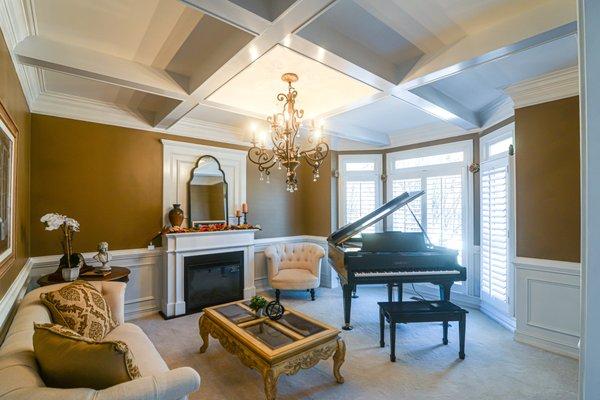 Coffered ceiling, waincoting, fireplace mantel surround.