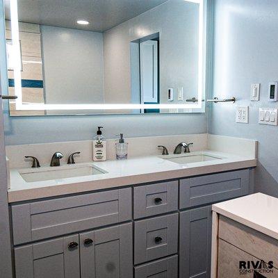 Side view of double sink with custom LED mirror