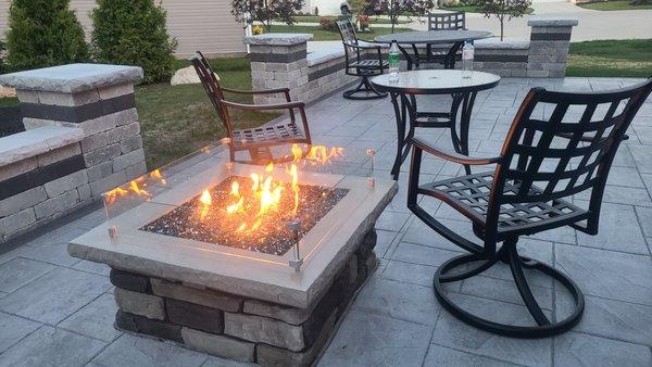 Large Ashlar Slate stamped patio complete with seat walls, columns and a custom-made natural gas fire pit.