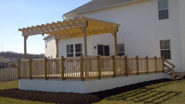 A simple but beautiful deck and pergola with cedar accents and rails.