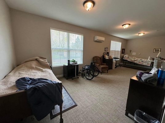 Shared bedroom. It was very large. My aunts lazy boy had a shelf fit full of photos.