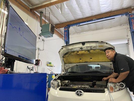 ASE Certified Shop Foreman Jose Mendez testing a MAF airflow for a high fuel consumption customer concern.