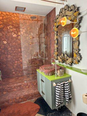 Beautiful Saltillo tile shower with custom vanity and stunning onyx vessel sink.