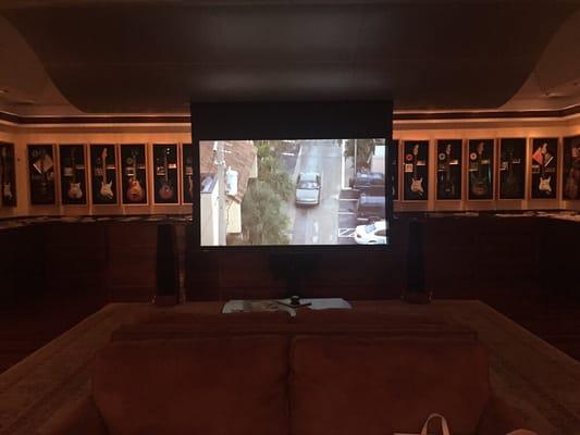 120" motorized screen with Sim2 projector in large media room