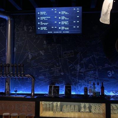 Inside bar area with flight map as the wall background to the bar.