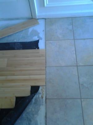 Running the bamboo flooring up to the tile job we just completed.