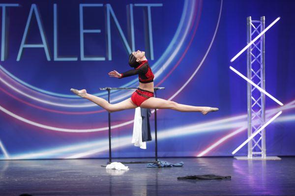 Competitive student Aubrey taking the sage with her solo.