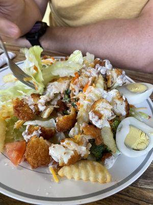 Crispy chicken salad comes with fries and hard boiled eggs. Filling and fresh.