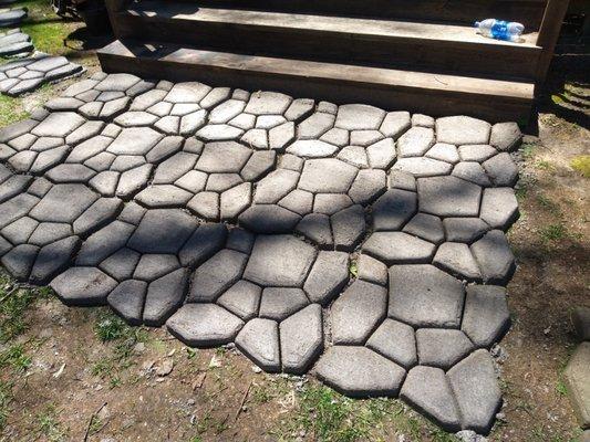 This is a molded concrete patio. It was layed on top of the soil but could also be sunk to be even with the ground