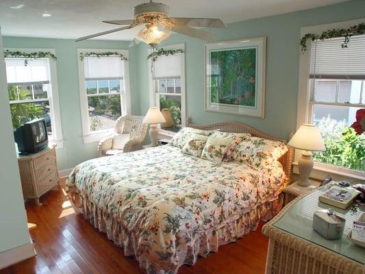 Master bedroom with 100 year old red heart pine floors and art by locals.