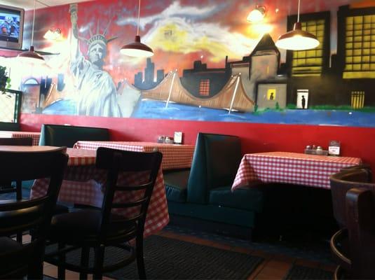 Dining area with a tv playing football.