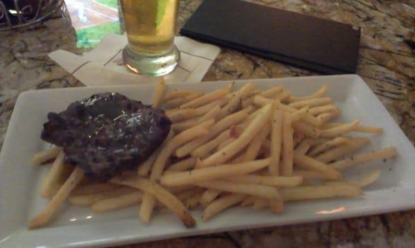 Fries with a dab of overdone steak.