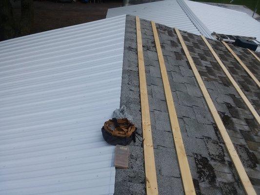 Steel roof over shingles